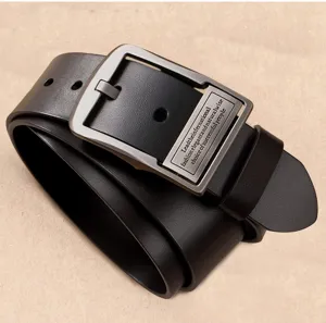 Detailed macro view of a men's retro black leather belt with a metal pin buckle.
