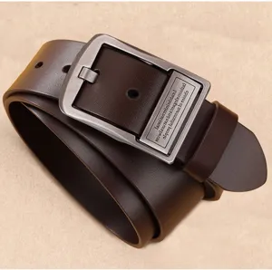 Detail shot of a dark brown men's leather belt with a vintage metal pin buckle.
