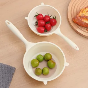 Set of two cream-white plastic kitchen colanders with handles for washing rice and fruit