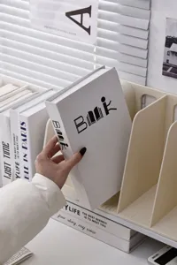 Cream plastic desk bookend organizer for office files and books on a white desk