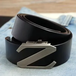 Detailed macro view of a men's black leather belt featuring a silver Z-shaped automatic buckle