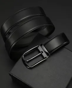 Close-up of premium black genuine leather belt with metallic buckle and gift box