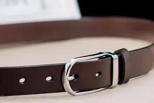 Macro view of high-quality 3.3cm men's brown leather belt with silver pin buckle