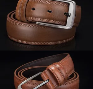 Close-up of brown leather belt with classic silver pin buckle and dual stitching