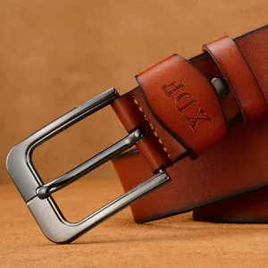 Vintage men's brown leather belt featuring a durable metal needle buckle close-up