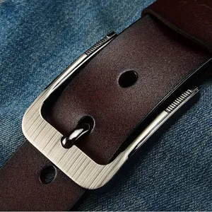 Vintage dark brown men's leather belt with a brushed silver pin buckle shown on denim.