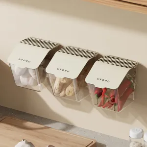 Three wall-mounted transparent flip-top storage boxes with checkered lids for kitchen organizing