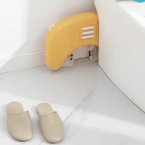 Ergonomic yellow plastic footstool with massage rollers for bathroom and office use