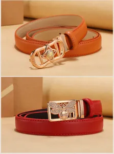 Macro detail of golden bee buckle and star buckle on leather waist belts for women