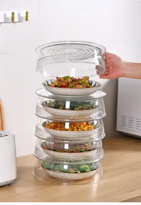 Detail view of stackable transparent food covers with breathable side holes in kitchen