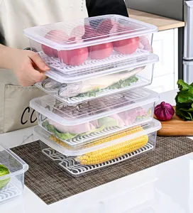 Stack of transparent food storage boxes with lids and drain trays for kitchen use