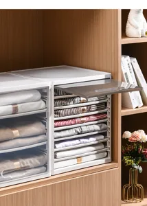 Close-up detail of stackable plastic wardrobe organizer with neatly folded shirts