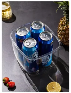 Close-up of a clear portable plastic ice bucket holding four chilled beverage cans