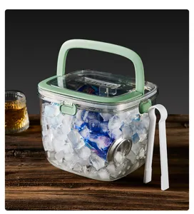 Close-up detail of portable clear plastic ice bucket with green handle and white tongs