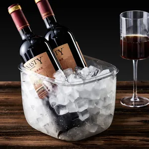 Large transparent acrylic ice bucket for chilling wine and beer on a rustic wooden table