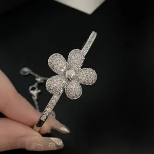 Macro view of a sparkling five-petal flower detail on a luxury silver zircon bracelet
