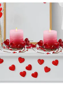 Decorative Valentine's Day heart berry candle rings with pink candles on a mantel