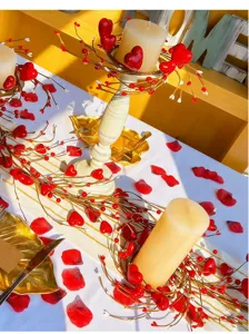 Detailed view of red heart berry candle rings on a decorated festive table