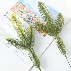 Close-up of lifelike artificial green pine branches for Christmas DIY wreath decor.