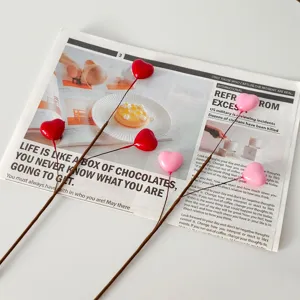 Primo piano di bacche decorative a cuore rosse e rosa per decorazione di San Valentino