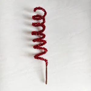Close-up of red tinsel glitter spiral decorative pick for festive Christmas ornaments