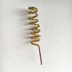 Macro view of a gold glitter spiral decorative branch for Christmas tree decor.