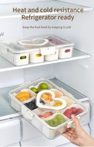 Macro view of divided refrigerator storage box filled with assorted fresh fruits.