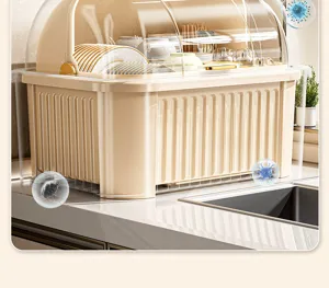 Detail view of cream kitchen dish drying rack with clear dust cover on countertop