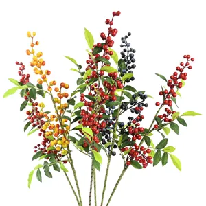 Detailed view of artificial berry stems with red, yellow and blue fruits and leaves
