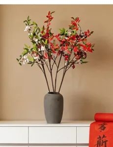 Detailed view of artificial Nandina domestica branches with vibrant red and white berries