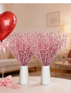 Two bundles of pink glitter berry stems in white vases for festive Valentine decor