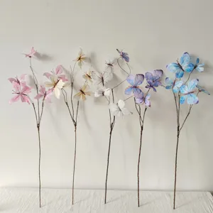 Detailansicht von fünf bunten dekorativen künstlichen Schmetterlings-Blumenzweigen