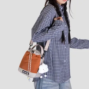 Stylish canvas crossbody bucket bag with cute cloud pendant, perfect for daily casual out.