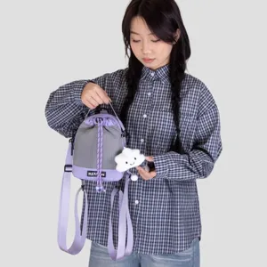 Detail view of the mini purple and grey drawstring backpack with cute cloud pendant.