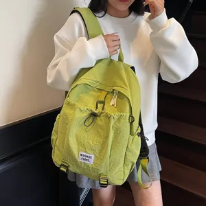 Casual lime green nylon backpack worn by a student on stairs, large capacity design.
