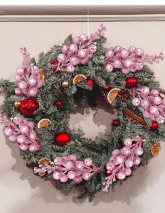 Festive Christmas wreath with pink glitter berries and pine branches for holiday wall decor.