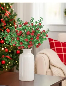 Artificial Christmas red and green glitter berry branch home decor in white ceramic vase detail