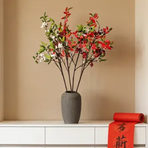 Vibrant artificial Nandina Domestica red berry branches in a modern gray ceramic vase.