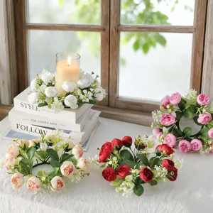 Detailed view of artificial tea rose candle rings in white, pink, and red styles.