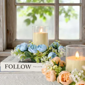 Detailed view of elegant floral candle ring with blue roses and glass holder decor