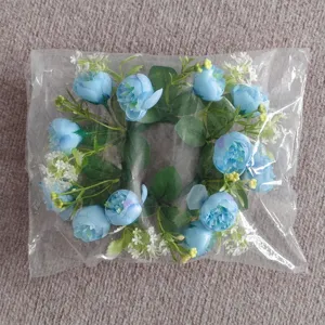 Close-up detail of blue tea rose and gypsophila floral wreath in a plastic bag