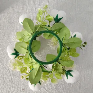 Underside view of artificial tea rose and gypsophila wreath for candle decoration