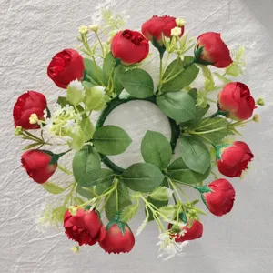 Detailed top-down view of a red artificial tea rose wreath with delicate white baby's breath