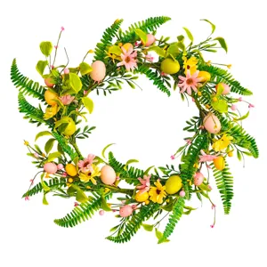 Detailed view of artificial Easter wreath with colorful eggs, fern leaves and floral decor.