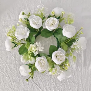 Detailed macro view of white tea rose and baby's breath floral candle wreath garland decor