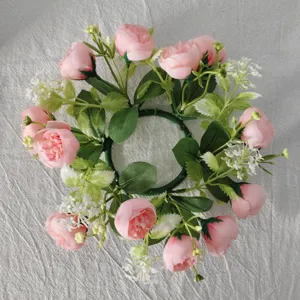 Detailed view of artificial pink rose and baby's breath floral candle ring wreath