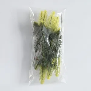 Detailed view of artificial pine branches packed in clear plastic bag for DIY decor