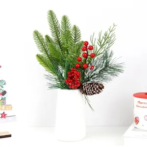Detailed view of artificial pine branches with red berries and pinecone for Christmas decor