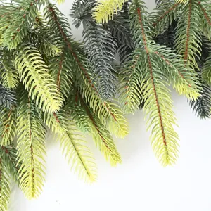Close-up macro view of realistic green artificial pine needles for Christmas DIY wreath decor