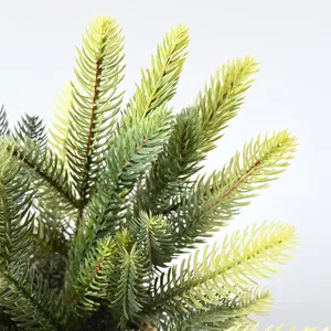 Close-up detail of realistic artificial green pine branches for Christmas DIY wreath decor.